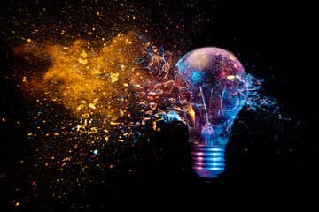 Colorful shattering lightbulb demonstrating breaking the norms